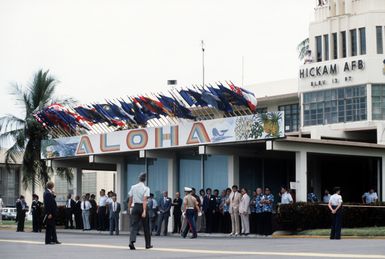 Hawaii Gov. George Ariyoshi (left) talks to another dignitary in front of the base operations building, as they wait to welcome the Prime Minister of Japan, Zenko Suzuki, for a visit