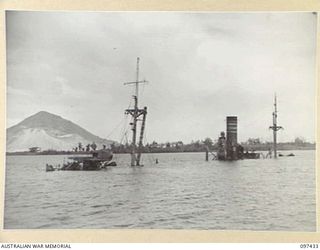 RABAUL, NEW BRITAIN. 1945-09-30. ONE OF MANY JAPANESE CARGO BOATS SUNK IN SIMPSON HARBOUR