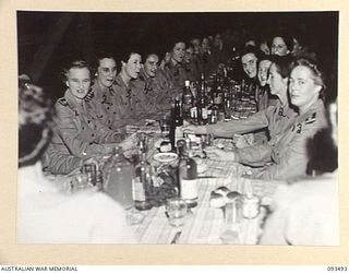 TOROKINA, BOUGAINVILLE. 1945-07-02. AUSTRALIAN ARMY NURSING SERVICE SISTERS IN THE SISTERS' MESS, 2/1 GENERAL HOSPITAL DURING A FORMAL DINNER CELEBRATING THE 43RD ANNIVERSARY OF THE AUSTRALIAN ARMY ..