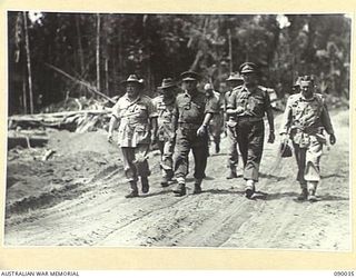 BOUGAINVILLE. 1945-03-26. GEN SIR THOMAS A. BLAMEY, COMMANDER-IN-CHIEF, ALLIED LAND FORCES, SOUTH WEST PACIFIC AREA (1), MOVING WITH SENIOR OFFICERS TO FORWARD POSITIONS DURING HIS TOUR OF HQ 7 ..