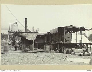 LAE, NEW GUINEA, 1944-03-25. THE REAR VIEW OF MOBILE PLANT AT THE 1ST MOBILE HOSPITAL LAUNDRY UNIT SHOWING THE BOILER AND PUMP WHICH DRAWS WATER FROM THE RIVER POSITIONED ALONGSIDE THE WASHING AND ..