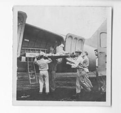 [Soldier on Strecher Being Placed on Plane, #1]