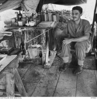 ORO BAY, NEW GUINEA. 1943-07. CORPORAL R.T. FRITH OPERATING A CENTRAFUGE IN THE PATHOLOGICAL TENT OF THE 10TH FIELD AMBULANCE