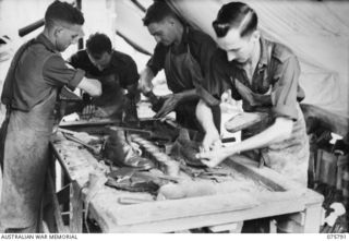 SIAR-NAGADA, NEW GUINEA. 1944-09-08. UNIT BOOTMAKERS WORKING IN THEIR SHOP, AT HEADQUARTERS, 61ST INFANTRY BATTALION "THE QUEENSLAND CAMERON HIGHLANDERS." IDENTIFIED PERSONNEL ARE:- Q28200 CORPORAL ..