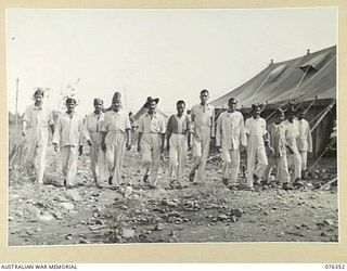 LAE, NEW GUINEA. 1944. INDIAN ARMY PERSONNEL, EX PRISONERS OF WAR OF THE JAPANESE, ENJOY A WALK IN THE SUNSHINE AT THE 2/7TH AUSTRALIAN GENERAL HOSPITAL. WHILE PRISONERS OF THE JAPANESE THESE MEN ..