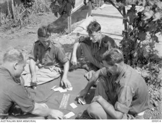 WEWAK POINT, NEW GUINEA. 1945-08-29. MEMBERS OF 2/8 INFANTRY BATTALION PLAYING CARDS. IDENTIFIED PERSONNEL ARE:- PRIVATE TRAPMAN (1); PRIVATE H. BIRMINGHAM (2); PRIVATE M. COLTISH (3); PRIVATE R.J. ..