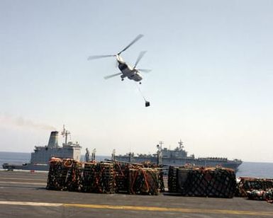 An HH-46D Sea Knight from Helicopter Combat Support Squadron 6 (HC-6) takes off with a pallet of supplies during an underway replenishment operation aboard the nuclear-powered aircraft carrier USS THEODORE ROOSEVELT (CVN-71). The fleet oiler USNS KANAWHA (T-AO-196) and the amphibious assault ship USS SAIPAN (LHA-2) are in the background. The ROOSEVELT Battle Group is assisting in enforcement of the no-fly zone over Bosnia-Herzegovina during Operation Deny Flight