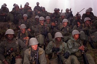 Members of the 1ST Battalion, 14th Infantry, 2nd Brigade, 25th Infantry Division, acting as opposing forces, take a break during training Exercise OPPORTUNE JOURNEY 4-83, at the US Army's Pohakuloa Training Area. The 25th Infantry Division is preparing for Team Spirit `84, a joint South Korean/US training exercise held annually in Korea