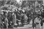 Pig festival, singsing, Kwiop: decorated men with feather headdresses dance with kundu drums