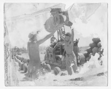 [Servicemen Moving Munitions]