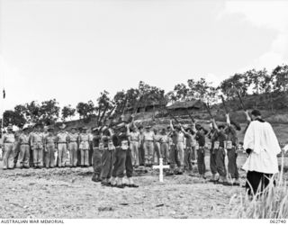 BOMANA WAR CEMETERY, PAPUA, NEW GUINEA. 1943-12-29. AT THE CONCLUSION OF A MEMORIAL SERVICE CONDUCTED BY CHAPLAIN J. D. MCKIE, CHURCH OF ENGLAND, A FIRING PARTY IN CHARGE OF QX226 SERGEANT N. L. ..