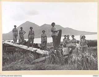 RABAUL, NEW BRITAIN. 1945-11-04. AUSTRALIAN ARMY MEDICAL WOMEN'S SERVICE PERSONNEL FROM 118 GENERAL HOSPITAL LOOKING AT THE WRECKAGE OF A JAPANESE PLANE AT THE END OF LAKUNAI AIRSTRIP