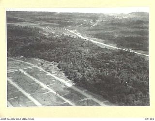 LAE, NEW GUINEA. 1944-03-30. AN AERIAL VIEW SHOWING THE TOWN IN THE BACKGROUND AND THE BULK ISSUE PETROL AND OIL DEPOT INSTALLATION IN THE FOREGROUND