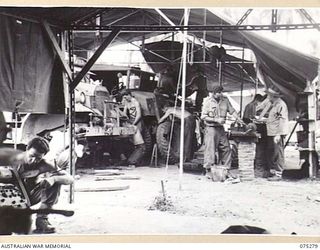 MADANG, NEW GUINEA. 1944-08-15. TROOPS OF THE 165TH GENERAL TRANSPORT COMPANY WORKING IN THE NO.16 SECTION OF THE UNIT WORKSHOPS. IDENTIFIED PERSONNEL ARE:- NX128939 PRIVATE W. COULTER (1); ..