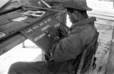 Malaysia, Republic of Fiji Military Forces soldier painting sign at camp