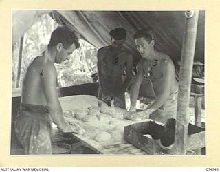 HANSA BAY, NEW GUINEA. 1944-07-29. BAKERS OF THE 30TH INFANTRY BATTALION FIELD BAKERY KNEADING UP BREAD IN THE UNIT BAKERY AT POTSDAM PLANTATION. IDENTIFIED PERSONNEL ARE:- NX122078 PRIVATE A. ..