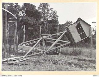 LAE AREA, NEW GUINEA. 1945-07-29. THE GUARD TOWER AT 16 DETENTION BARRACKS WHICH WAS CHOPPED DOWN BY INTERNEES