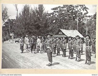 MOTUPENA POINT, BOUGAINVILLE, 1945-07-04. HIS ROYAL HIGHNESS, THE DUKE OF GLOUCESTER, GOVERNOR-GENERAL OF AUSTRALIA (1), ACCOMPANIED BY CAPTAIN W.A.J. HILL (2), INSPECTING FRONT RANK OF GUARD OF ..
