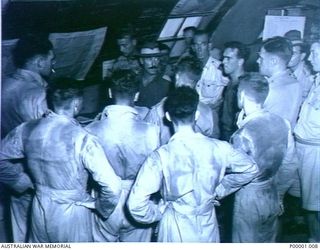 THE SOLOMON ISLANDS, 1945-01-09. AN AUSTRALIAN ARMY MAJOR BRIEFING RNZAF AIRCREW BEFORE A STRIKE AGAINST THE JAPANESE. (RNZAF OFFICIAL PHOTOGRAPH.)