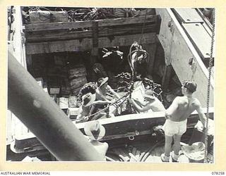 SIPAAI, BOUGAINVILLE ISLAND. 1945-01-07. TROOPS OF THE 42ND LANDING CRAFT COMPANY UNLOADING SUPPLIES AND EQUIPMENT OF THE 31/51ST INFANTRY BATTALION FROM THE HOLD OF THE AV1361 "POOLTA" AT THE ..