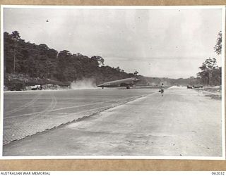 DREGER HARBOUR, NEW GUINEA. 1943-12-07. A DOUGLAS TRANSPORT IS THE FIRST LARGE AIRCRAFT TO LAND ON THE NEW STRIP BUILT BY THE 870TH UNITED STATES AVIATION BATTALION