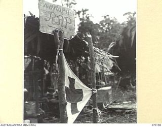 KOROPA, NEW GUINEA. 1944-02-03. AN IMPROVISED TIN NOTICE WITH THE LOCATION WRONGLY-SPELT IDENTIFIES THE ADVANCED DRESSING STATION ESTABLISHED TO CATER FOR 57/60TH INFANTRY BATTALION WOUNDED FROM ..