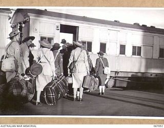 TOWNSVILLE, NORTH QUEENSLAND, AUSTRALIA. 1944-06-27. AUSTRALIAN ARMY MEDICAL WOMEN'S SERVICE PERSONNEL ENTRAINING ON THE WHARF AFTER THEIR RETURN TO AUSTRALIA FROM NEW GUINEA