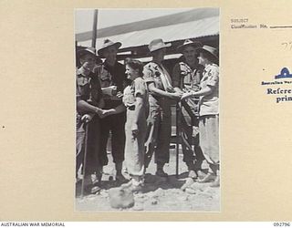 LAE, NEW GUINEA. 1945-06-09. PRIVATE T. RYAN, AUSTRALIAN ARMY MEDICAL WOMEN'S SERVICE (3) AND THE RED CROSS SOCIETY ASSISTANT SUPERINTENDENT R.A. PARROTT (6), FAREWELL PATIENTS AT 2/7 GENERAL ..