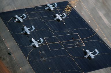 An aerial view of six OV-10A Bronco aircraft of the 22nd Tactical Air Support Squadron on the flight line during Exercise OPPORTUNE JOURNEY 85-3