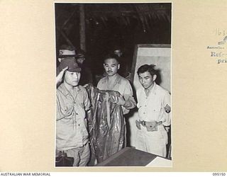 TOKO, BOUGAINVILLE, 1945-08-18. MAJOR OTSU, A MEMBER OF A SURRENDER ENVOY FROM LIEUTENANT-GENERAL M. KANDA, COMMANDER IMPERIAL JAPANESE 17 ARMY GROUP, SALUTES AS HE PREPARES TO LEAVE HEADQUARTERS 3 ..