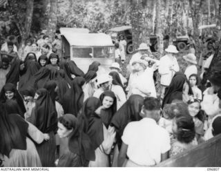 Ramale Mission, Kokopo Area, New Britain. The farewell scene as twenty of a group of 300 white former internees leave Ramale Mission for evacuation to Rabaul to receive medical treatment at 4 Field ..