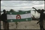 Men holding up a Christian Fellowship Church flag