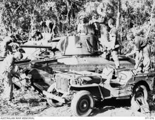 KILIGIA, NEW GUINEA. 1944-03-16. TANK CREWS OF A SQUADRON, 1ST TANK BATTALION, 5TH DIVISION, REPLENISHING MATILDA TANKS WITH 3 INCH HOWITZER AMMUNITION BROUGHT BY JEEP TRANSPORT DURING MANUEUVERS