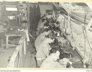 LAE, NEW GUINEA. 1944-09-28. MOTORISED MACHINES IN USE IN THE WORKROOM OF THE TAILORING SECTION OF THE OFFICERS' SHOP, HEADQUARTERS NEW GUINEA FORCE. IDENTIFIED PERSONNEL ARE:- Q132327 CORPORAL ..