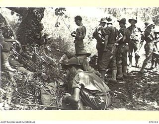 KETOBA, NEW GUINEA. 1944-01-29. 11TH PLATOON "B" COMPANY, 57/60TH INFANTRY BATTALION, PICTURED AT REST ON THE TRACK AFTER HAVING CAPTURED ORGORUNA WITHOUT OPPOSITION. HEAVY GOING ON THE TRACK MAKES ..