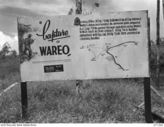 FINSCHHAFEN AREA, NEW GUINEA. 1944-03-18. ONE OF MANY BATTLE SIGNS IN NEW GUINEA AND THE AREA, THIS SIGN RECORDS ACTIVITIES OF THE 2/23RD AND 2/24TH INFANTRY BATTALIONS AT BAZULUO AND IN THE ..