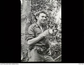 Goodview Junction, New Guinea. 1943-09-15. Private Colin Gatgens of Newcastle, NSW, with hand grenades attached around his waist, after returning with an Australian patrol which inflicted numerous ..