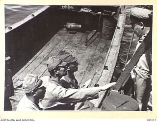 AT SEA, OFF BUIN, BOUGAINVILLE, 1945-08-20. A MEMBER OF THE JAPANESE ENVOY HOLDING A MESSAGE FOR LIEUTENANT-GENERAL M. KANDA, COMMANDER IMPERIAL JAPANESE 17 ARMY GROUP, AND BEING ADVISED THAT THE ..