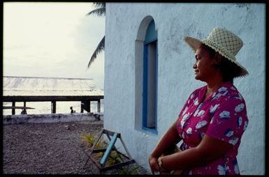 Woman outside a church, Cook Islands