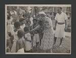 Woman greeting children, in background is Colonel JK Murray and Ivan Champion, Papua New Guinea, c1949