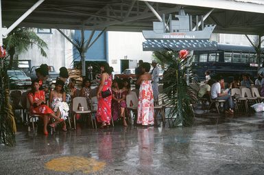 Family and friends of the crewmen aboard the combat stores ship USS NIAGARA FALLS (AFS 3) wait under a pavilion at Naval Station Guam for the ship to dock