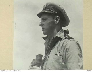 AT SEA. 1944-09/08. SUB-LIEUTENANT R. SLUTZKIN, RAN, ANTI-SUBMARINE OFFICER ABOARD THE RAN COVETTE, GEELONG DOING HIS TURN AT WATCH AS THE VESSEL PROCEEDS ALONG THE NEW GUINEA COAST