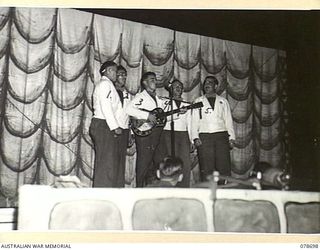 BOUGAINVILLE ISLAND. 1945-01-27. A QUARTET SINGING POPULAR SONGS DURING A CONCERT STAGED BY THE 58/59TH INFANTRY BATTALION PLAYERS AT THE 2ND AUSTRALIAN CORPS HEADQUARTERS. IDENTIFIED PERSONNEL ..