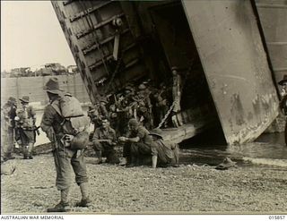New Guinea. 1943-09-29. Troops disembarking from a Landing Ship, Tank (LST), for the attack on Finschhafen. They have landed on a beach six miles away