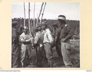 MUSCHU ISLAND, NEW GUINEA, 1945-09-08. MAJOR T. FOGARTY, G2, 6 DIVISION EXPLAINING TO OUR INTERPRETERS WHAT HE WANTS THE JAPANESE COMMANDER TO DO AS REGARDS CONSTRUCTION OF THE HOSPITAL. THE ..