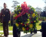 A US Marine Corps (USMC) Marine stands at attention after placing a wreath on an artillery piece, at a dedication ceremony for an artillery gun park in Camp Lejeune, North Carolina (NC). The park was named after USMC Private First Class (PFC) Harold C. Agerholm, 4th Battalion, 10th Marines, 2nd Marine Division, who received the Medal of Honor posthumously during World War II for action against Japanese forces on Saipan and rescuing forty-five casualties under heavy enemy fire