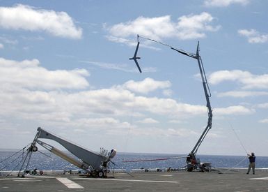 An unmanned aerial vehicle (UAV) called the"Scan Eagle"lands in the skyhook for recovery on the flight deck aboard the U.S. Navy Tarawa Class Amphibious Assault Ship USS SAIPAN (LHA 2) during operations in the Atlantic Ocean on Aug. 18, 2006. The"Scan Eagle"is designed to provide persistent intelligence, surveillance and reconnaissance data, battle damage assessment and communications relay in support of the Global War On Terrorism. (U.S. Navy photo by Mass Communication SPECIALIST SEAMAN Patrick W. Mullen III) (Released)