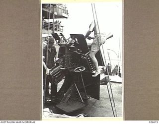 PORT MORESBY, PAPUA. 1942-09. GUNNERS ON THIS 2 PDR MK IIC ANTI-AIRCRAFT GUN ABOARD HMAS BENDIGO KEEP THEIR GUN IN GOOD ORDER - JUST IN CASE
