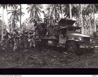 LANGEMAK AREA, NEW GUINEA. 1943-11-01. TROOPS OF THE 870TH UNITED STATES ENGINEER AVIATION BATTALION UNLOADING SUPPLIES IN THE GODOWA AREA IN PREPARATION FOR THE BUILDING OF A NEW ROAD TO THE ..