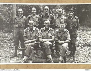 HUON PENINSULA, NEW GUINEA. 1944-01-14. PERSONNEL OF A BRANCH, HEADQUARTERS, 9TH DIVISION. FRONT ROW, LEFT TO RIGHT: QX6227 CAPTAIN D. D. WHALLEY; QX6450 MAJOR N. W. LOCKYER; QX8002 WARRANT OFFICER ..